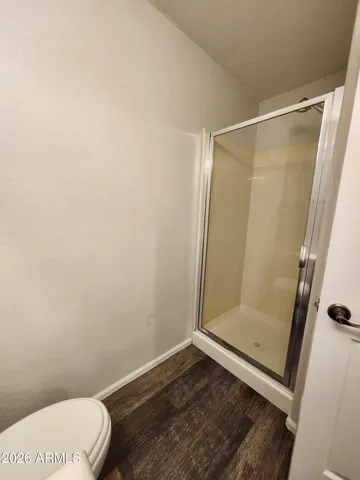 a view of a hallway with wooden floor and stairs