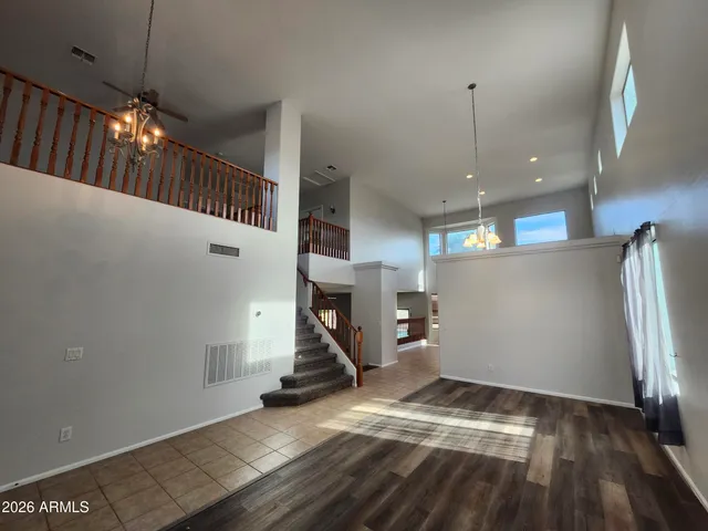 a view of a livingroom with wooden floor and stairs
