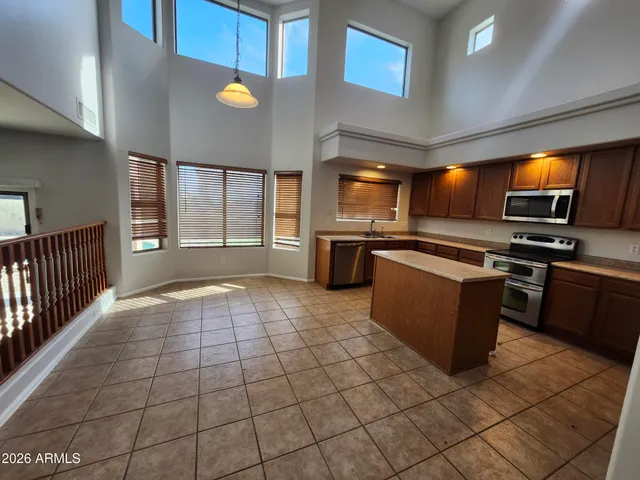 a kitchen with stainless steel appliances a stove a sink and a refrigerator