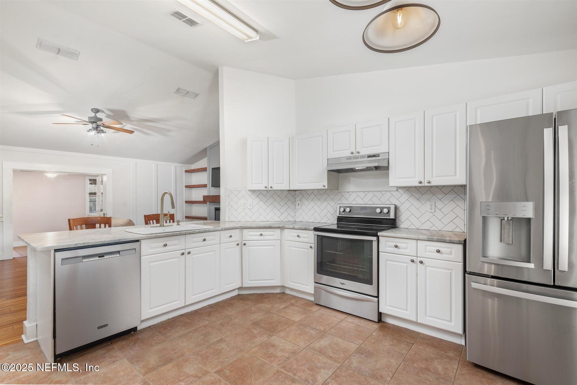 113 Mohegan Road St. Augustine, FL 32086 - Photo 15 of 56 a kitchen with cabinets stainless steel appliances and a counter space