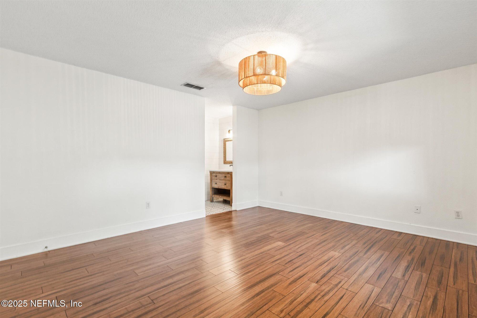 113 Mohegan Road St. Augustine, FL 32086 - Photo 20 of 56 an empty room with wooden floor and window