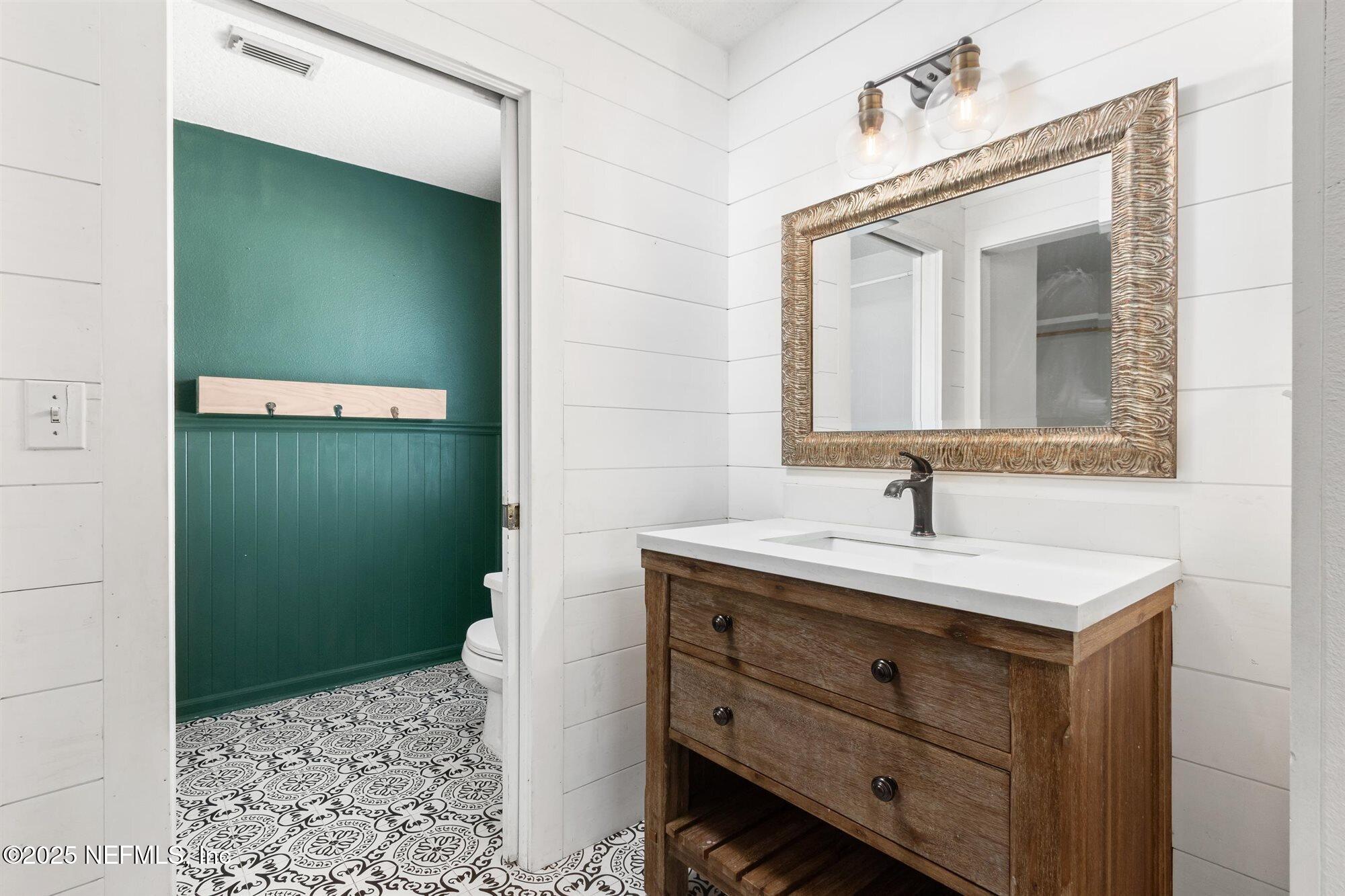 113 Mohegan Road St. Augustine, FL 32086 - Photo 23 of 56 a bathroom with a sink and a mirror