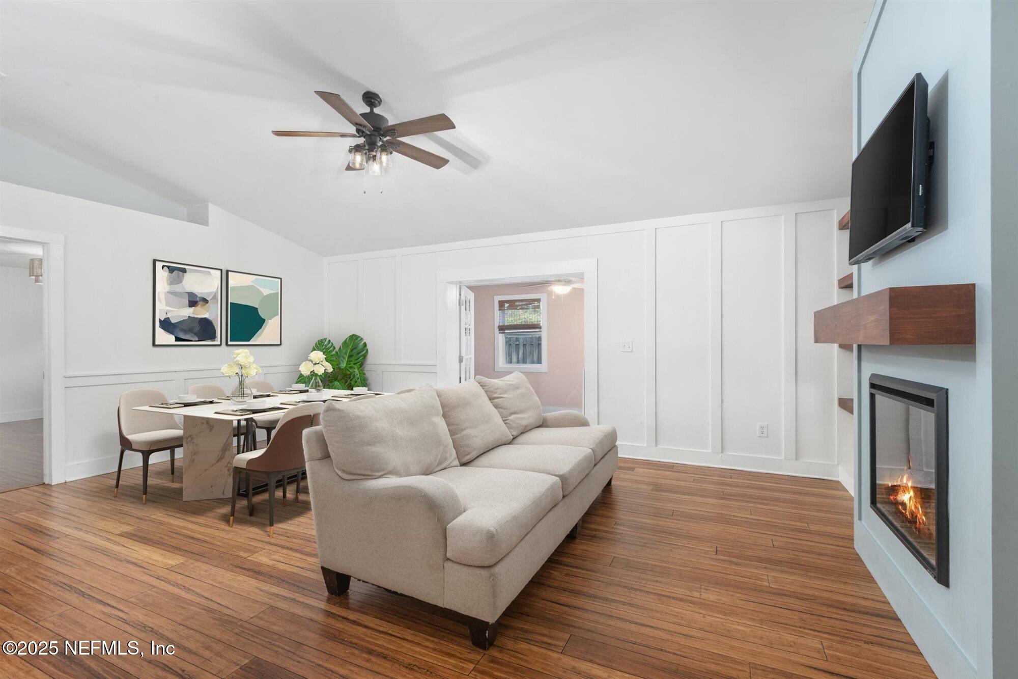 113 Mohegan Road St. Augustine, FL 32086 - Photo 10 of 56 a living room with furniture a fireplace and a flat screen tv