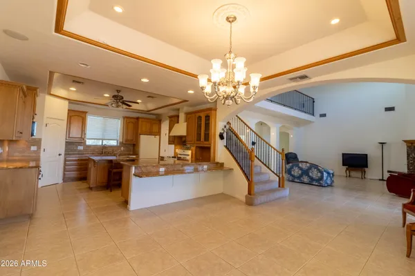 a large kitchen with stainless steel appliances granite countertop a stove a sink dishwasher and cabinets with wooden floor
