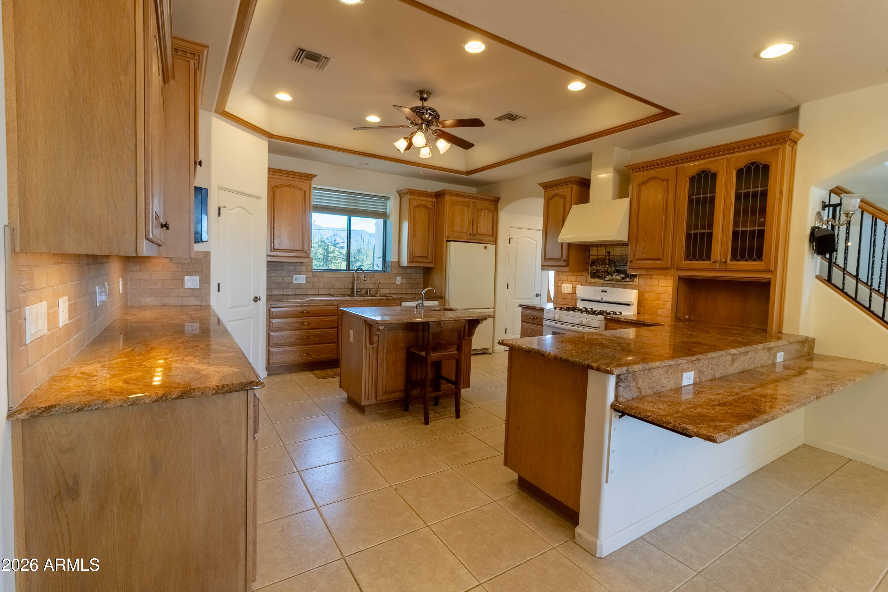5159 North Lak A Yucca Road Tucson, AZ 85743 - Photo 20 of 66 a kitchen with granite countertop a sink counter top space and stainless steel appliances