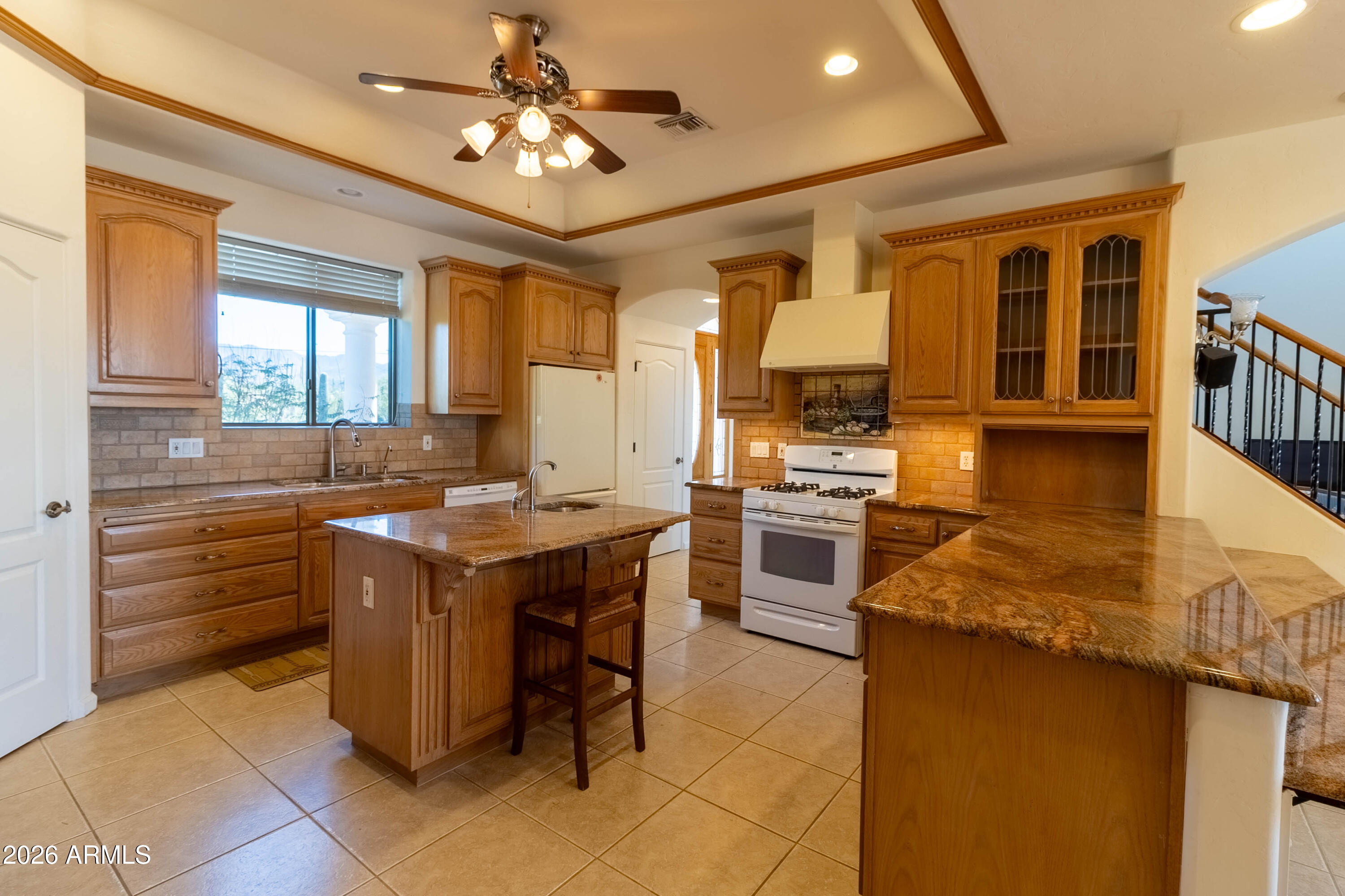 5159 North Lak A Yucca Road Tucson, AZ 85743 - Photo 21 of 66 a kitchen with kitchen island granite countertop a sink counter top space appliances and a window