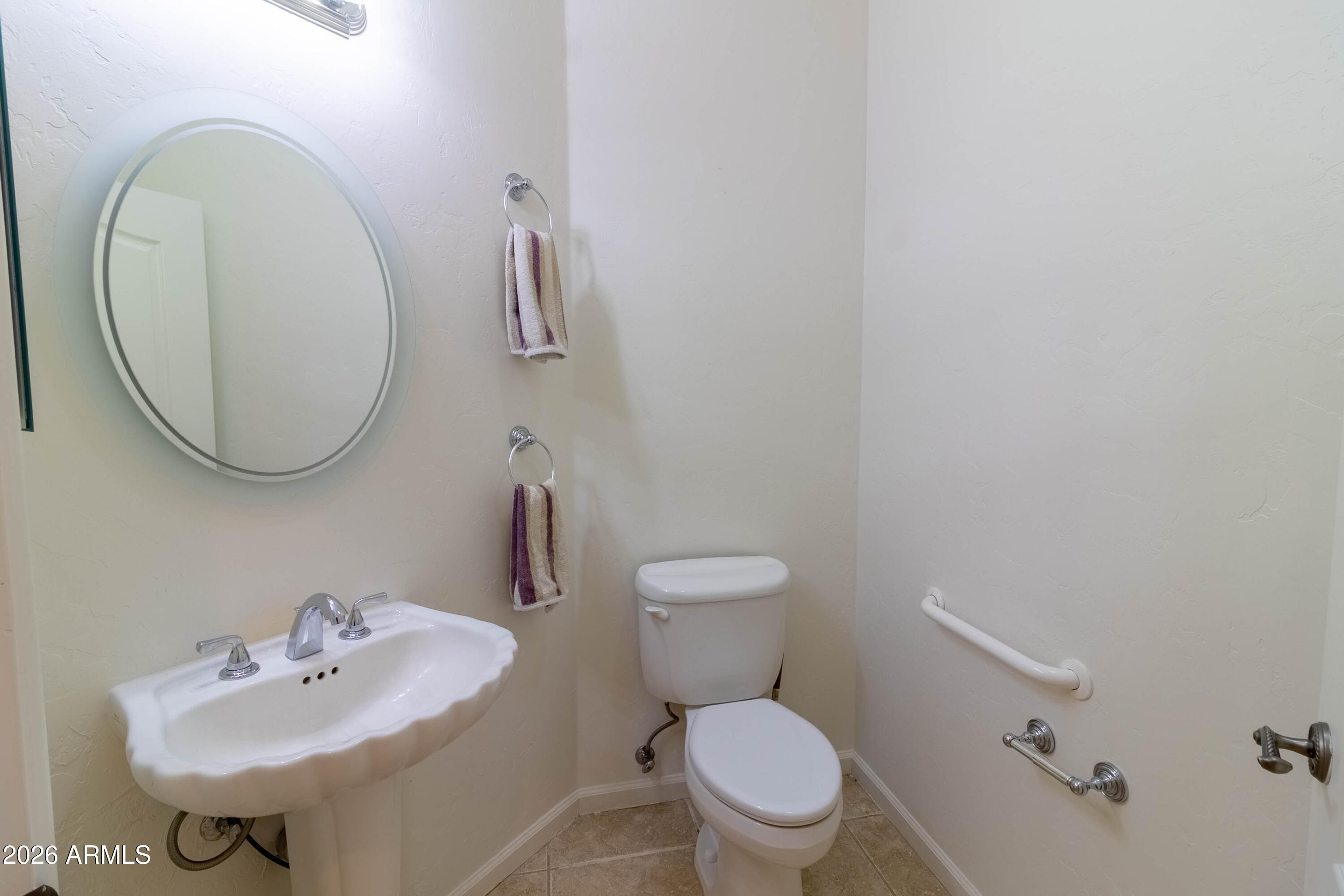 5159 North Lak A Yucca Road Tucson, AZ 85743 - Photo 33 of 66 a bathroom with a sink a mirror and a toilet