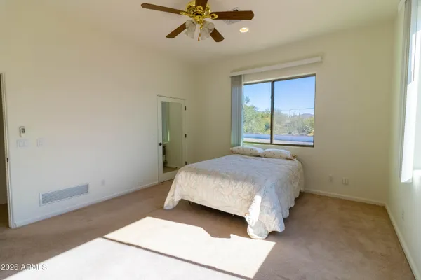 a bedroom with a bed and a potted plant