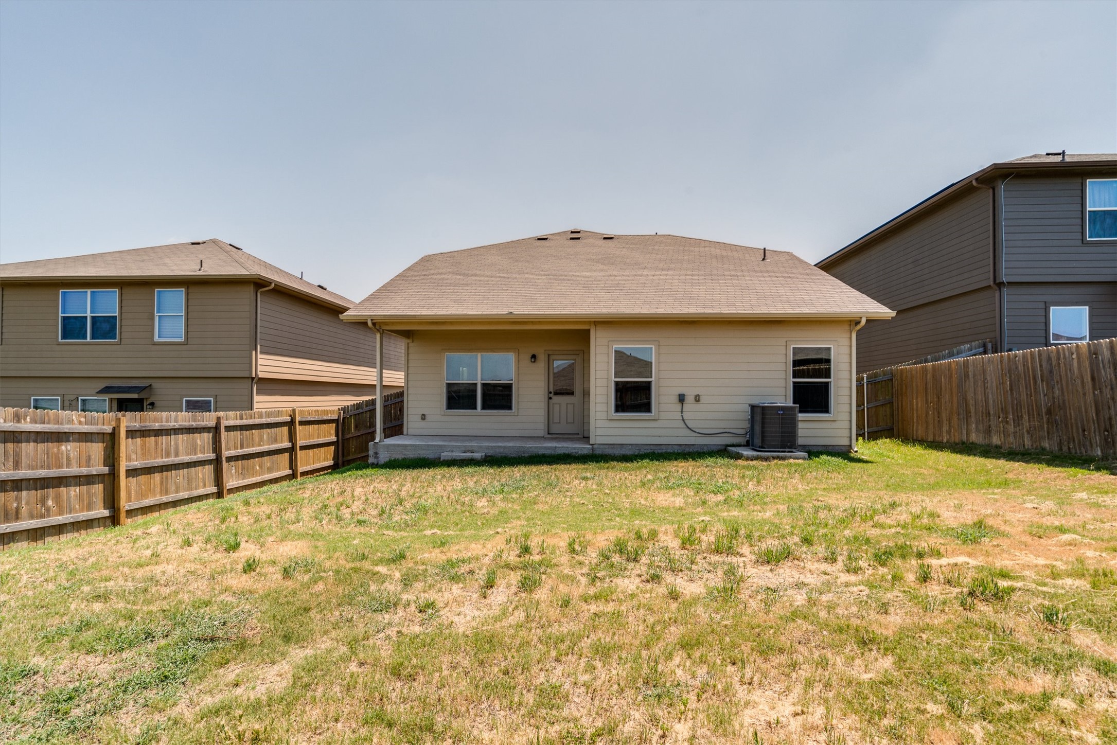 15128 Shell Bark Cove Austin, TX 78724 - Photo 23 of 25 A spacious backyard awaits, fully fenced for privacy and outdoor enjoyment.