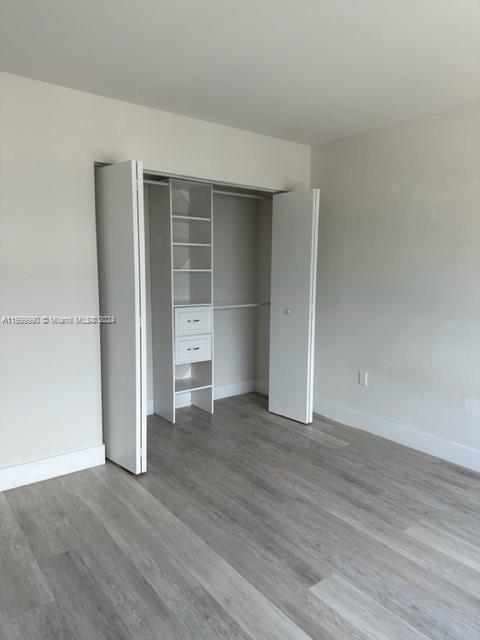 2561 Northeast 193rd Street, Unit 1207 Miami, FL 33180 - Photo 13 of 21 an empty room with wooden floor and closet