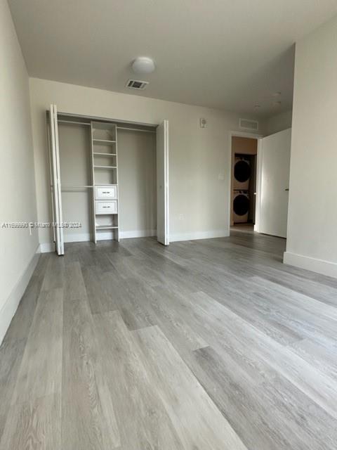 2561 Northeast 193rd Street, Unit 1207 Miami, FL 33180 - Photo 17 of 21 an empty room with wooden floor and closet