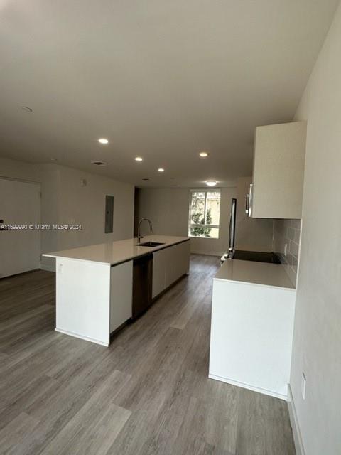 2561 Northeast 193rd Street, Unit 1207 Miami, FL 33180 - Photo 3 of 21 a large kitchen with stainless steel appliances a large counter top a stove and a refrigerator