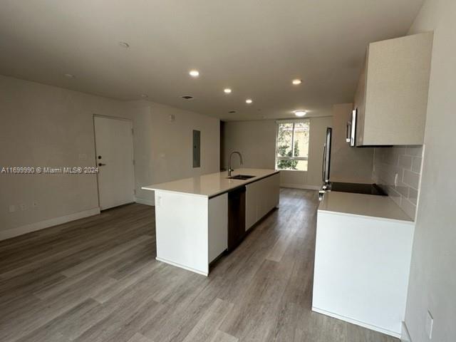 2561 Northeast 193rd Street, Unit 1207 Miami, FL 33180 - Photo 4 of 21 a large kitchen with stainless steel appliances a large counter top a stove and a refrigerator