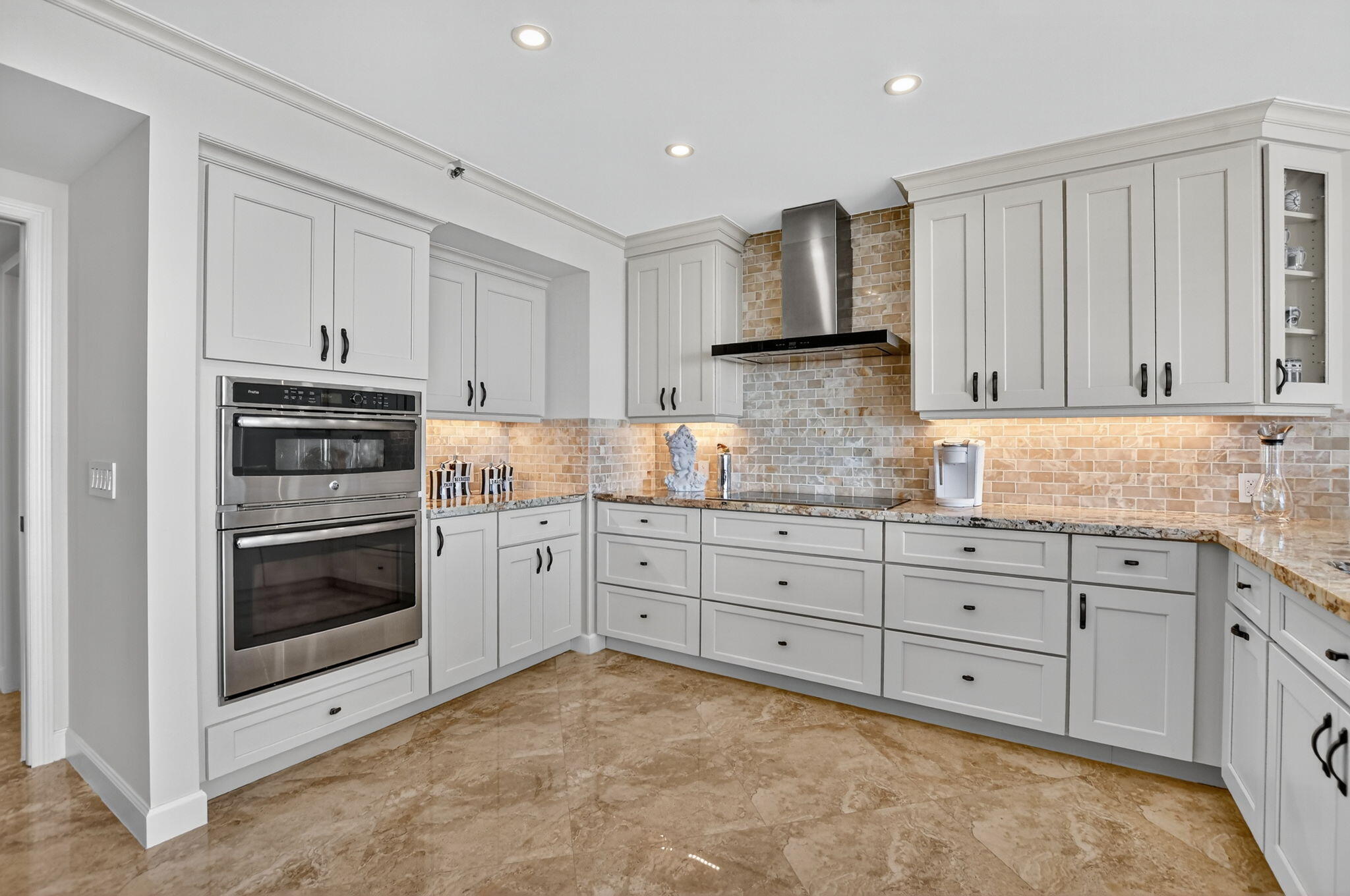 1500 South Ocean Boulevard, Unit 704 Boca Raton, FL 33432 - Photo 13 of 78 a kitchen with granite countertop white cabinets and stainless steel appliances