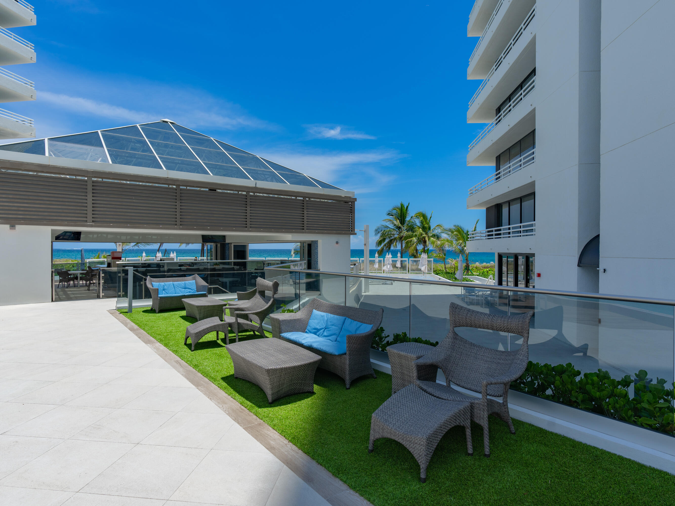 1500 South Ocean Boulevard, Unit 704 Boca Raton, FL 33432 - Photo 58 of 78 a view of a patio with couches table and chairs with potted plants and wooden fence