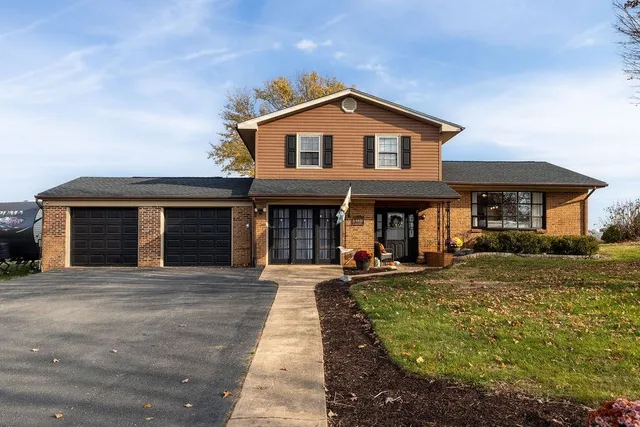 a front view of a house with yard and porch