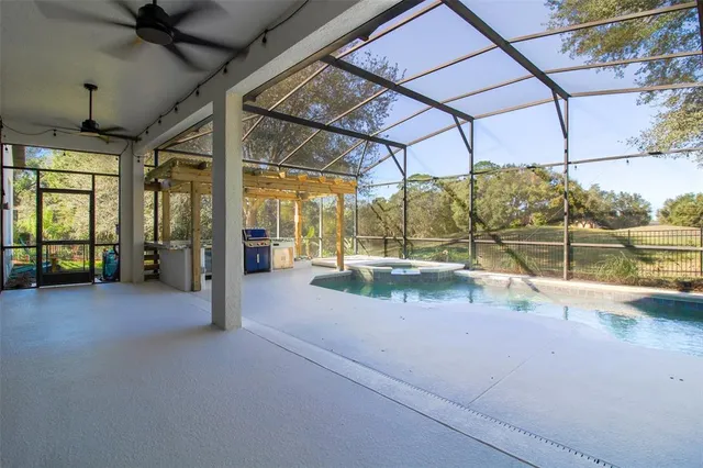 a kitchen with stainless steel appliances a stove top oven a sink dishwasher and a refrigerator with wooden floor