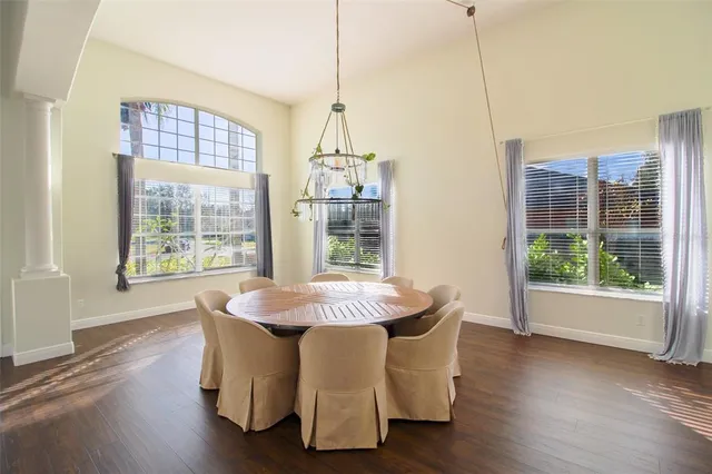 a view of a livingroom with wooden floor and stairs