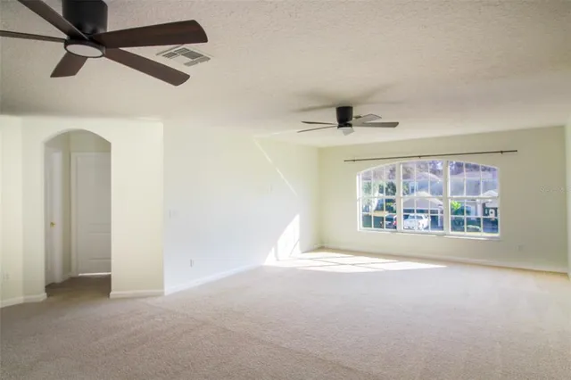 a view of a room with a ceiling fan