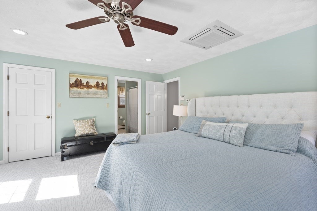 8 Penbrook Circle Andover, MA 01810 - Photo 20 of 42 a bedroom with a bed and a chandelier