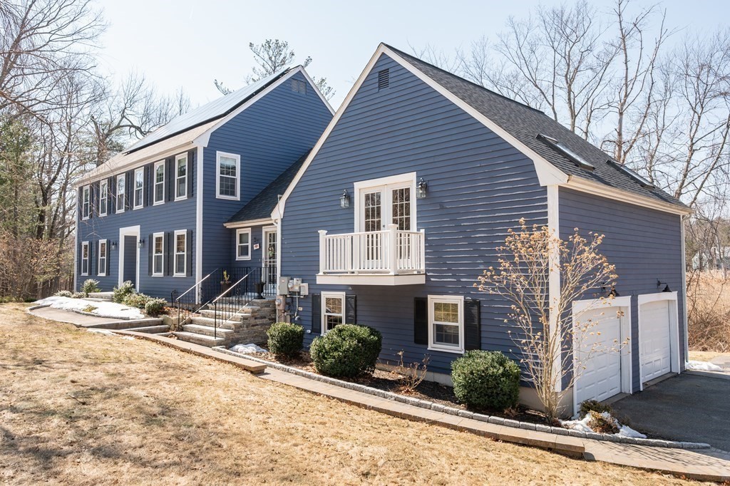 8 Penbrook Circle Andover, MA 01810 - Photo 3 of 42 a front view of a house with a yard and garage