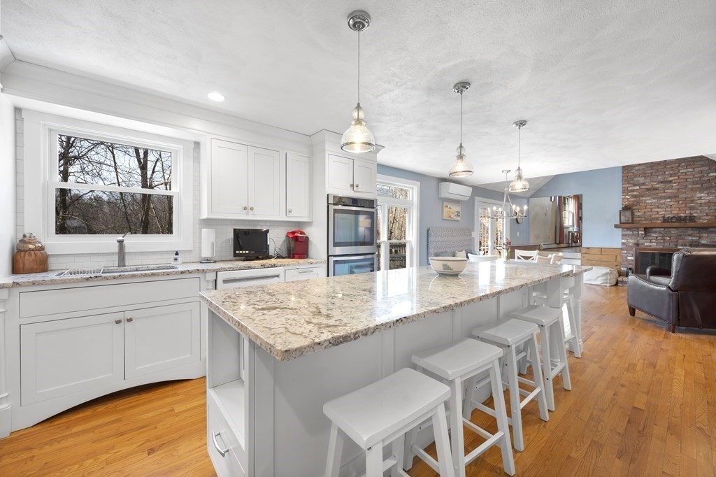8 Penbrook Circle Andover, MA 01810 - Photo 4 of 42 a kitchen with stainless steel appliances granite countertop sink stove top oven and cabinets