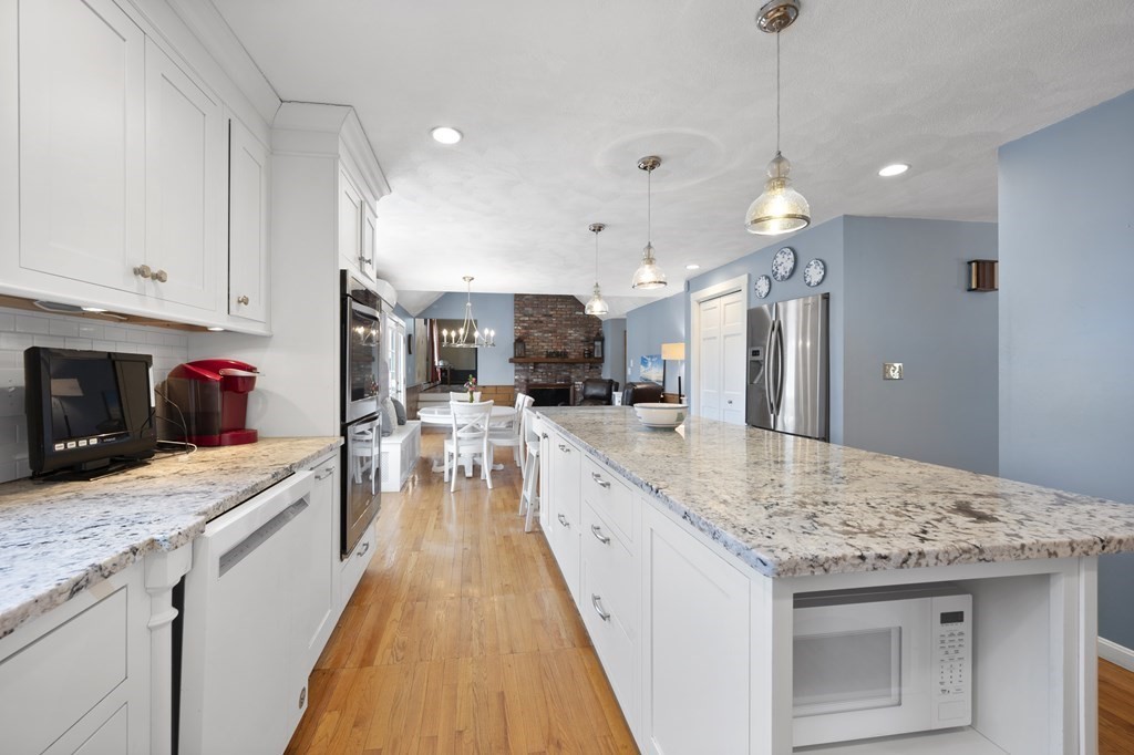 8 Penbrook Circle Andover, MA 01810 - Photo 5 of 42 a large kitchen with kitchen island a sink stainless steel appliances and cabinets