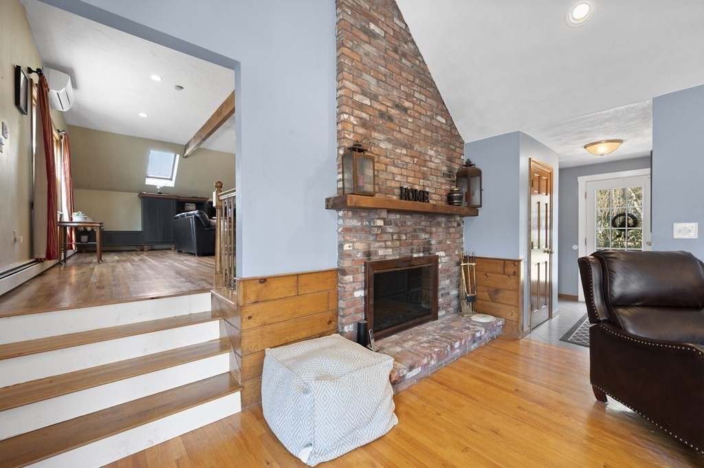 8 Penbrook Circle Andover, MA 01810 - Photo 8 of 42 a living room with furniture a fireplace and a flat screen tv