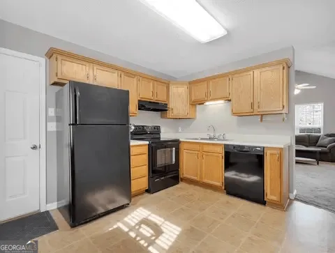 a kitchen with a refrigerator stove and sink