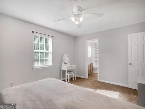 a view of a livingroom with furniture and chandelier fan