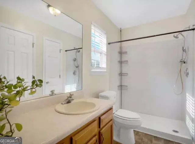a bathroom with a sink toilet and shower