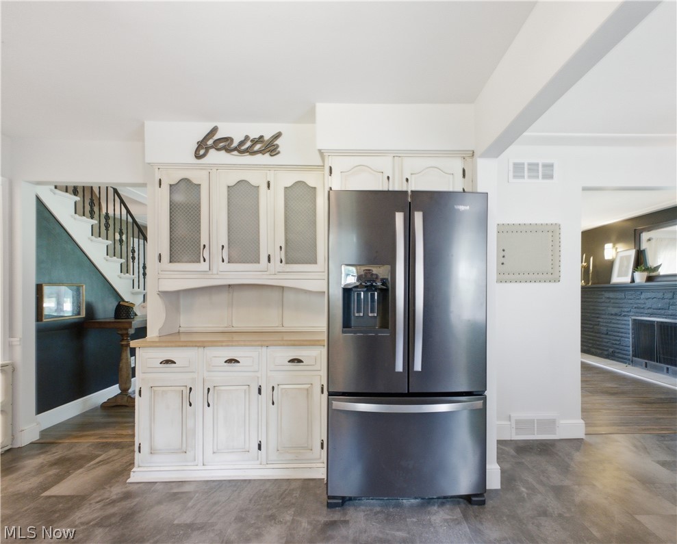 2411 Ridgeview Lane Youngstown, OH 44514 - Photo 10 of 48 Distressed white cabinetry with a light wood-finish countertop, integrated with a stainless steel French door refrigerator