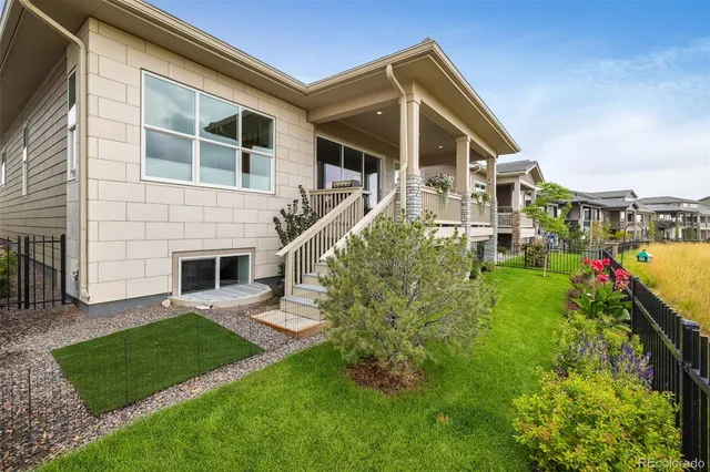 a front view of a house with a yard and ocean view