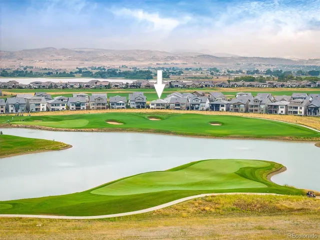 an aerial view of residential houses with outdoor space and swimming pool