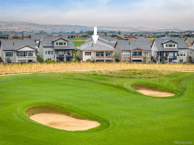 an aerial view of a house with a big yard