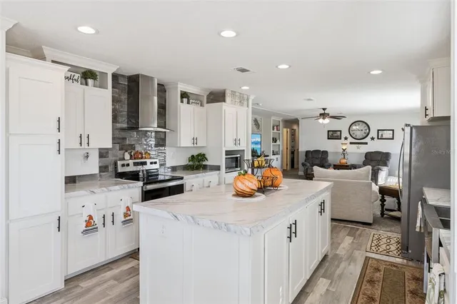 a kitchen filled with white cabinets and white appliances
