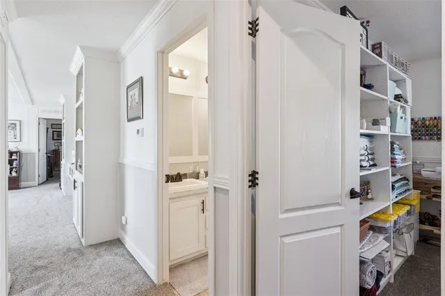 a bedroom with furniture and a book shelf