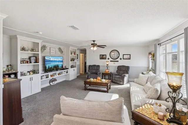 a living room with furniture and flat screen tv