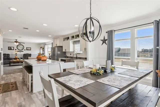 a large kitchen with a table and chairs