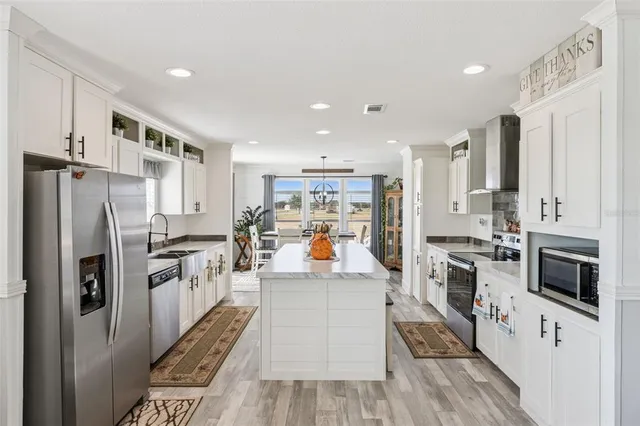 a large kitchen with stainless steel appliances and a refrigerator