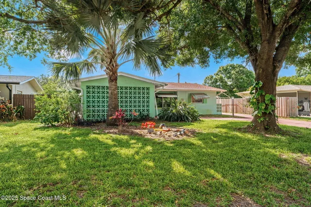 a view of a house with a tree in a yard