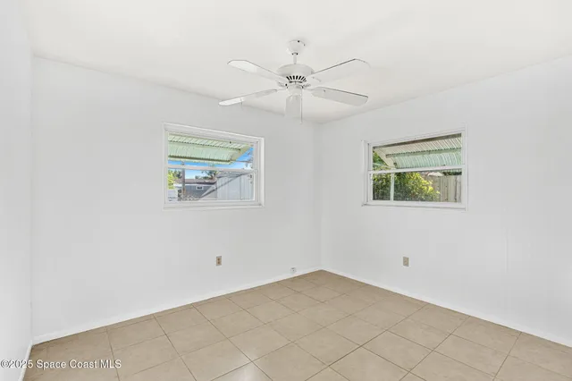 a view of a house with backyard and trees