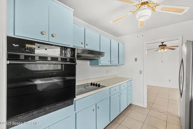 a kitchen with cabinets and stainless steel appliances