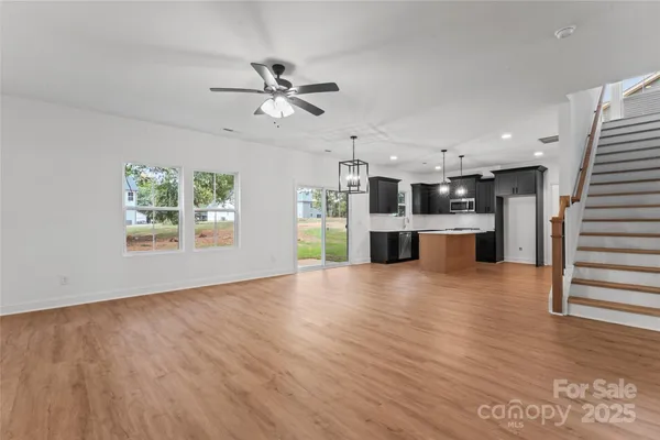 a view of a kitchen with a dishwasher cabinets and a large window