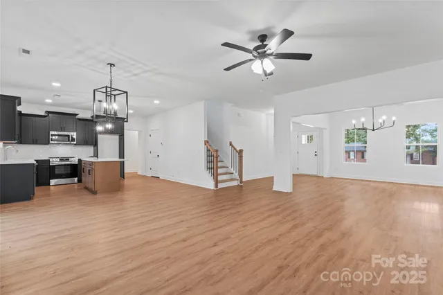 a view of a kitchen with a sink and wooden floor