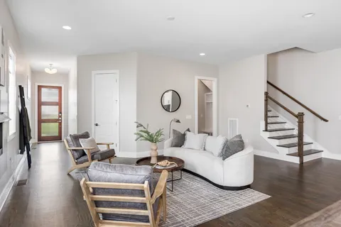 a living room with furniture and wooden floor