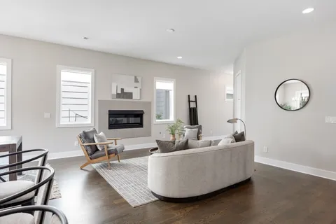 a living room with furniture wooden floor and a fireplace