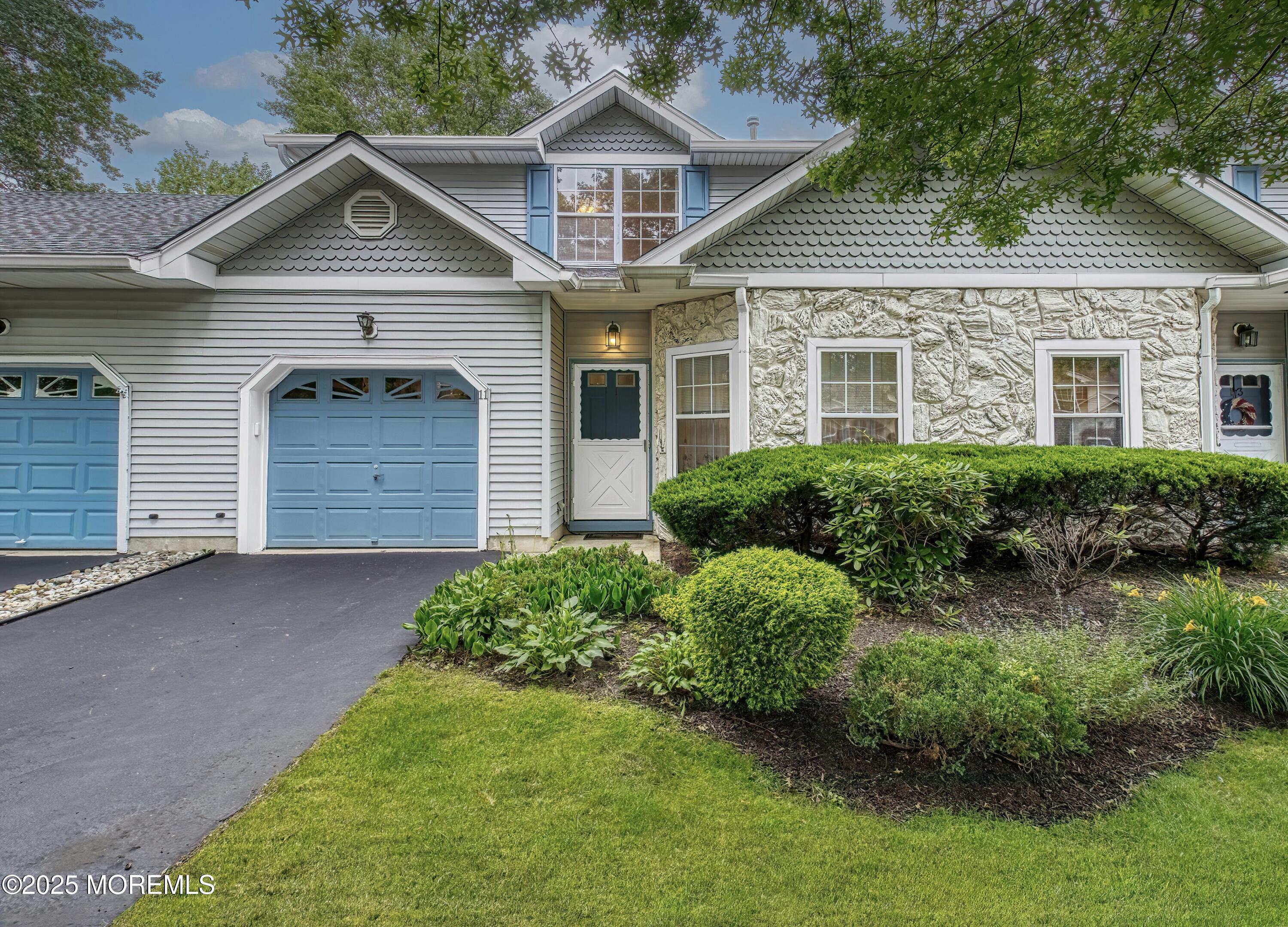 11 Riva Boulevard Brick, NJ 08723 - Photo 1 of 42 a front view of a house with a yard and garage