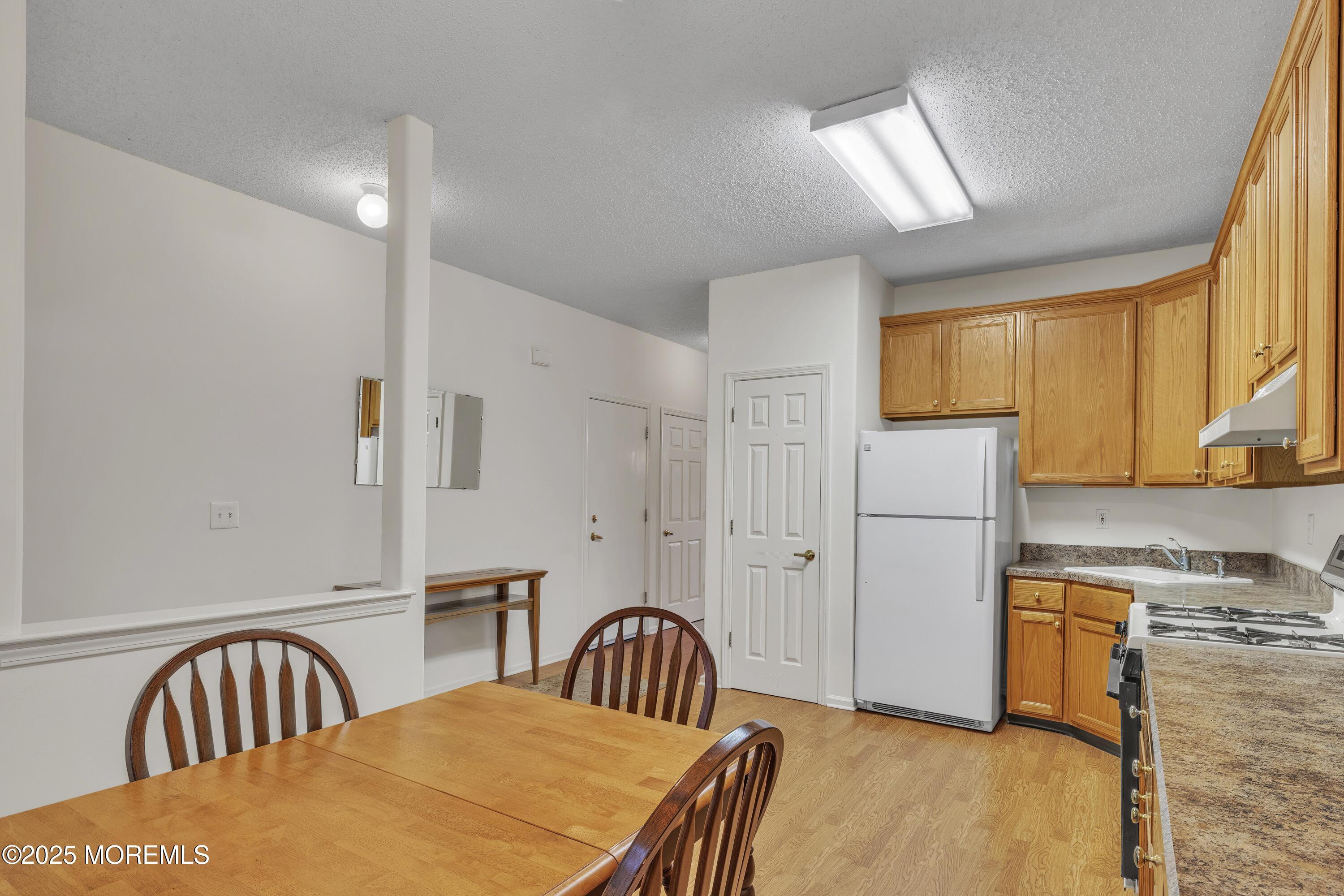 11 Riva Boulevard Brick, NJ 08723 - Photo 15 of 42 a bedroom with a bed next to a window with kitchen view