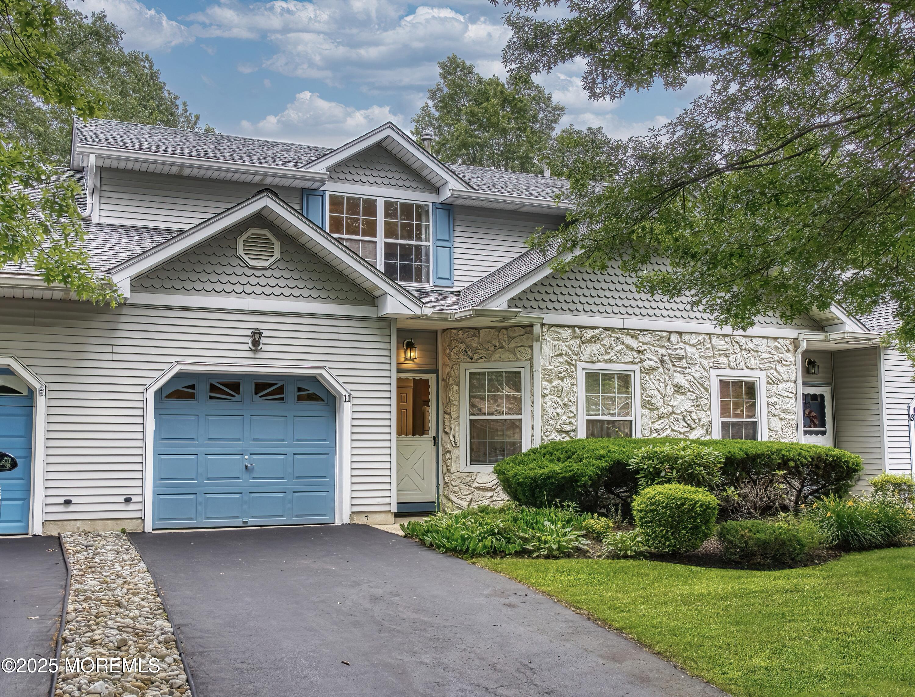 11 Riva Boulevard Brick, NJ 08723 - Photo 2 of 42 a front view of a house with a garden